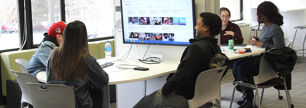 Students work together on a project at one of the computer stations at the Digital Commons at BCC.