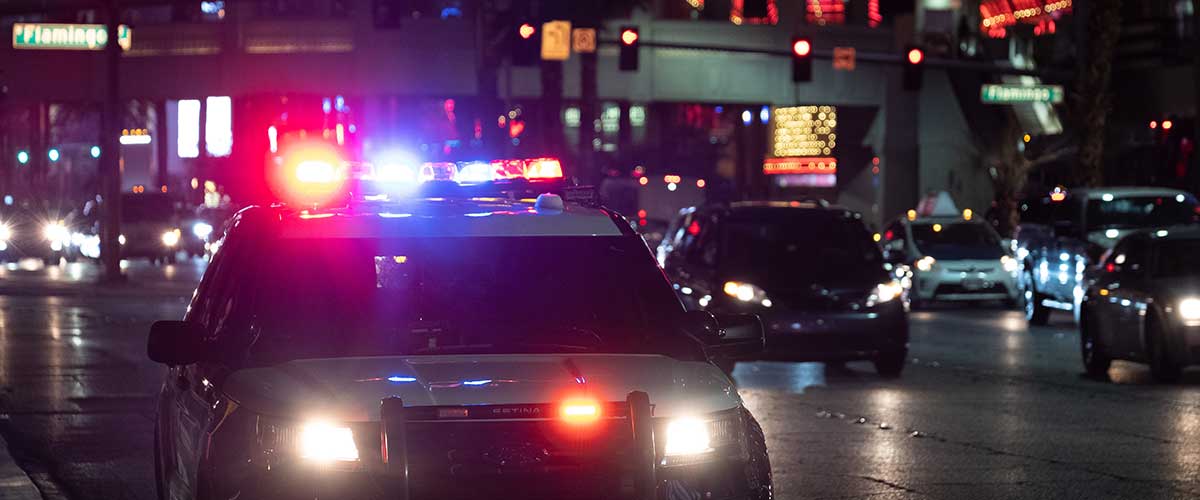 Police car with lights at night on a busy street